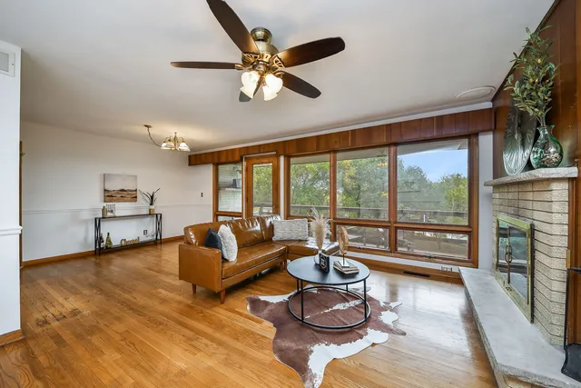 a living room with furniture and a floor to ceiling window