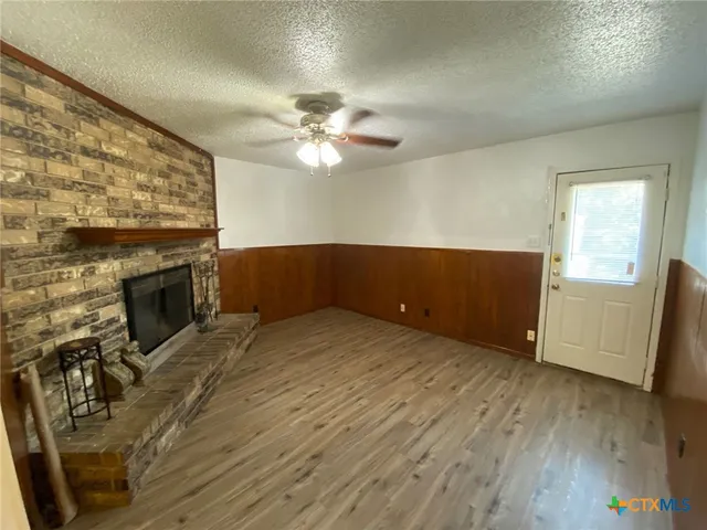 wooden floor in an empty room with a fireplace