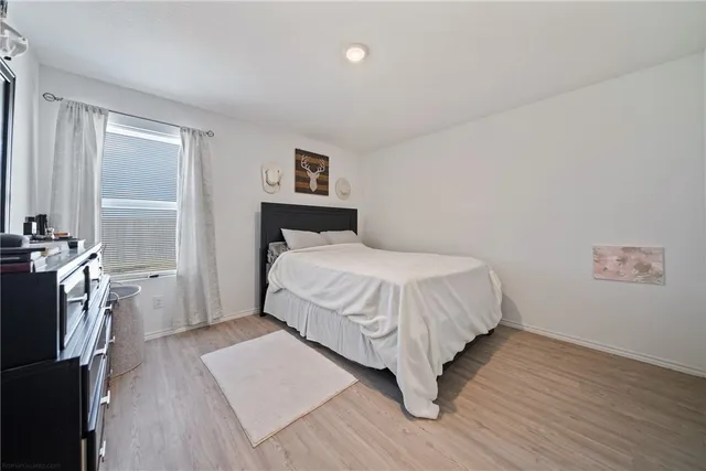 a bedroom with a bed and a night stand