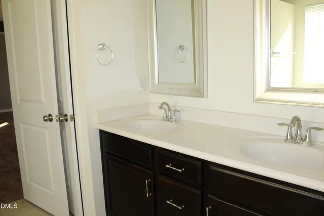 a bathroom with a double vanity sink and mirror