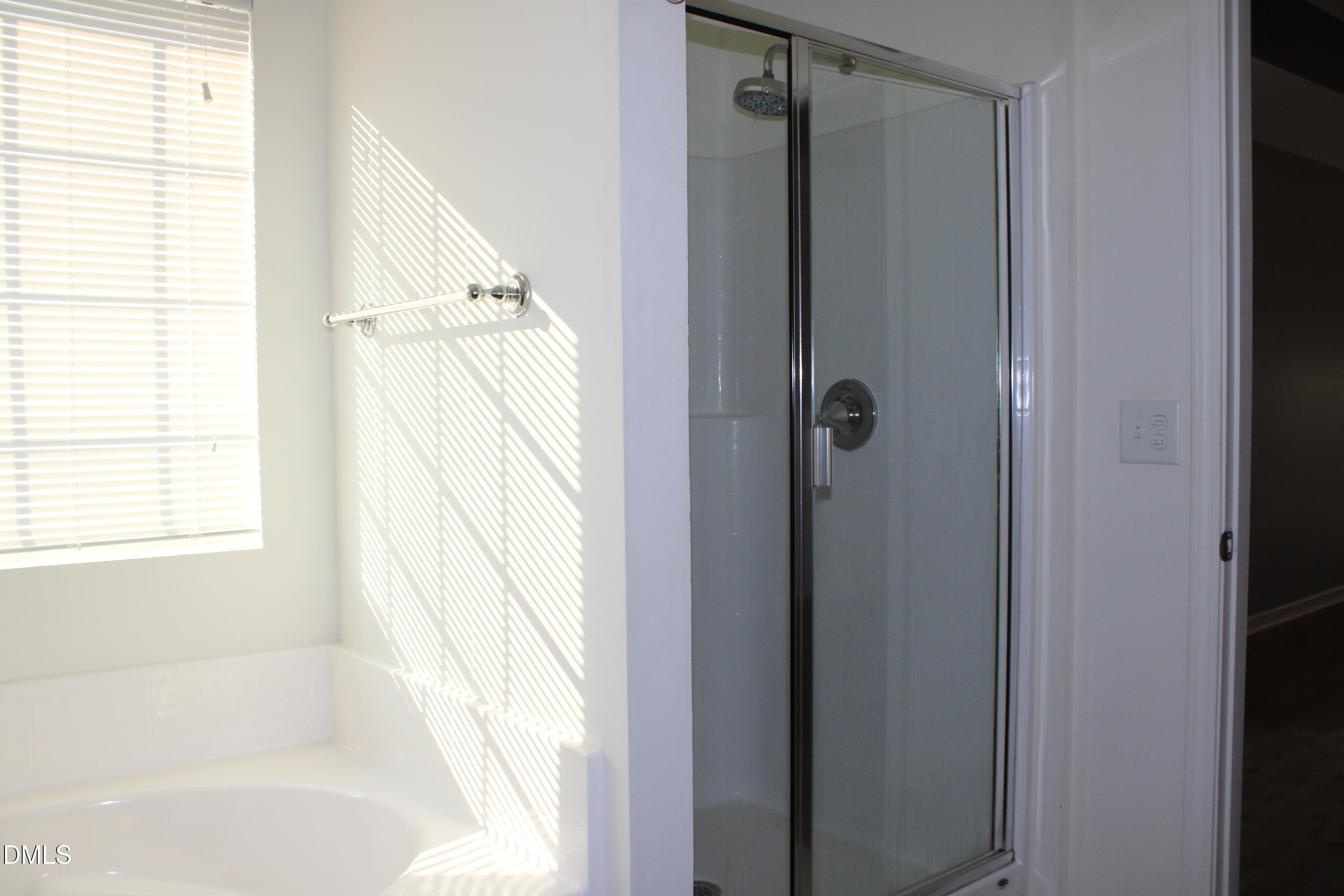 138 Lyonshall Street Fuquay-Varina, NC 27526 - Photo 17 of 24 a bathroom with a bathtub a shower and a window
