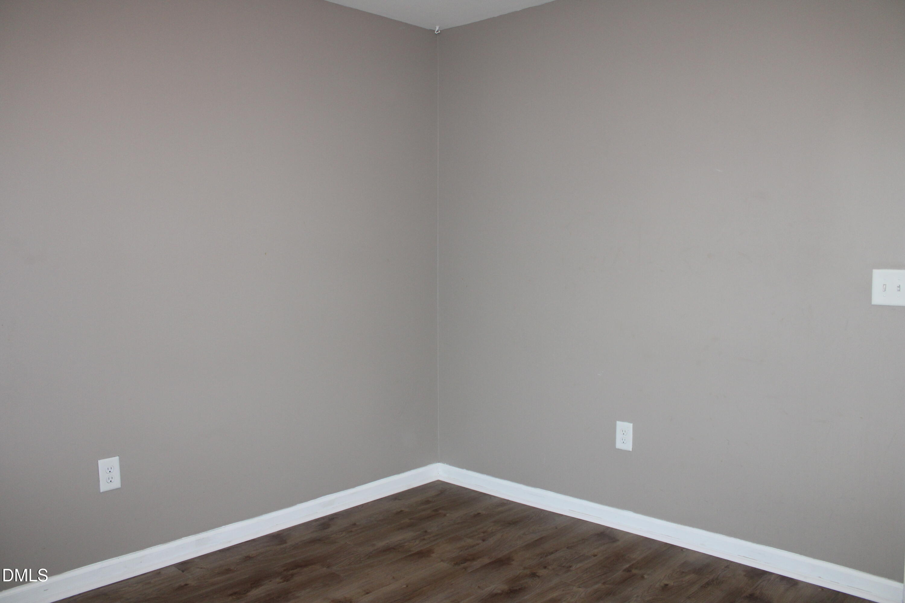 138 Lyonshall Street Fuquay-Varina, NC 27526 - Photo 19 of 24 a view of an empty room with wooden floor