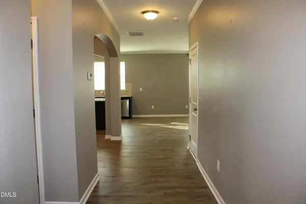 a view of a hallway with wooden floor
