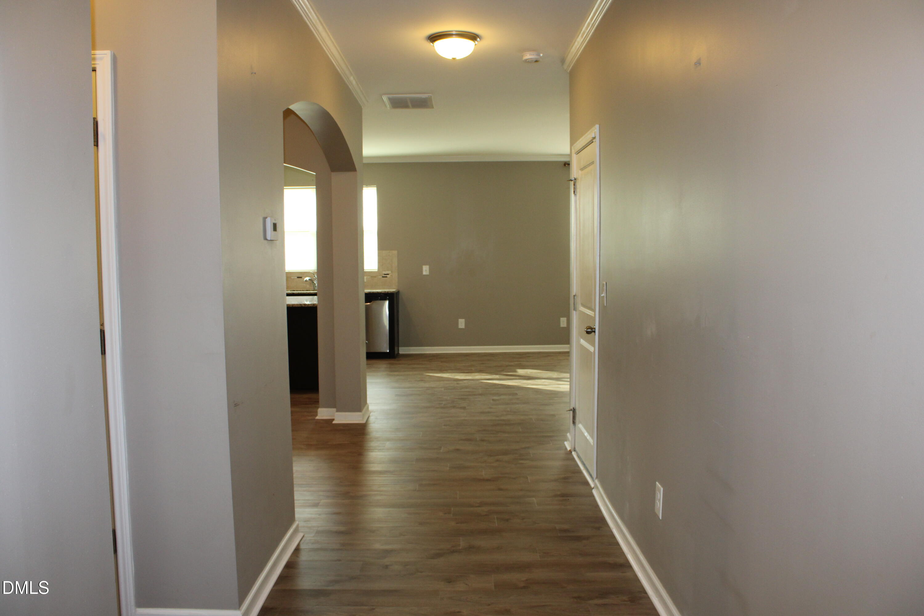 138 Lyonshall Street Fuquay-Varina, NC 27526 - Photo 2 of 24 a view of a hallway with wooden floor