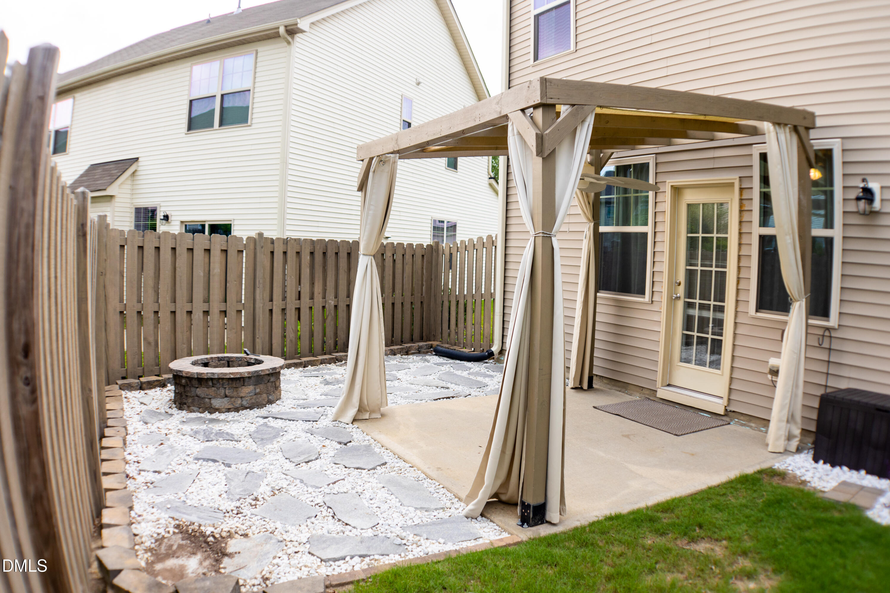 138 Lyonshall Street Fuquay-Varina, NC 27526 - Photo 23 of 24 a view of a porch with a floor to ceiling window and potted plants