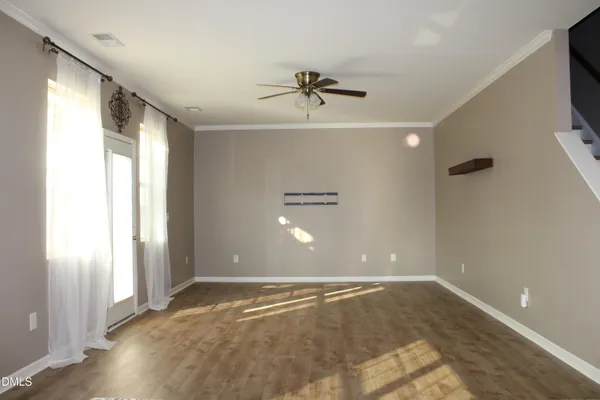 wooden floor in an empty room with a window