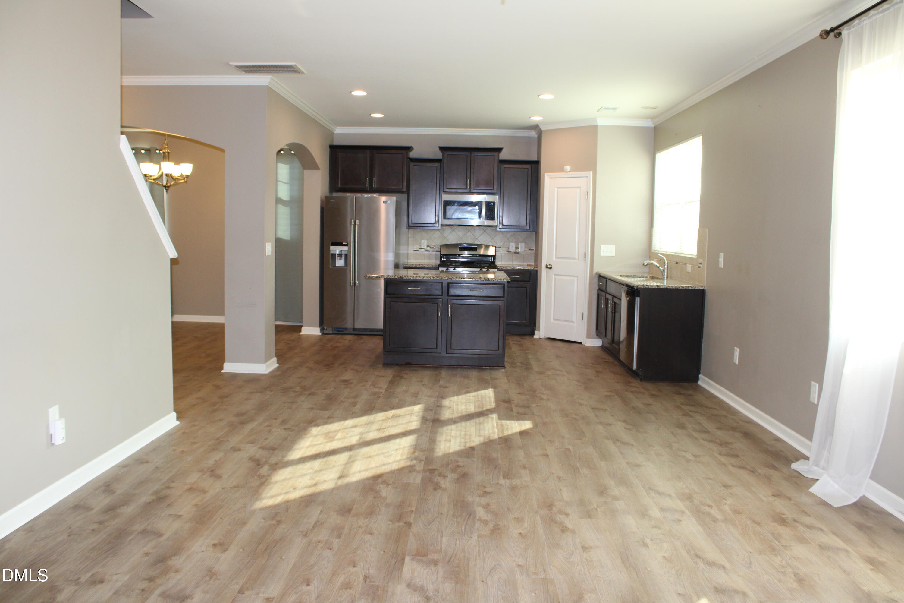 138 Lyonshall Street Fuquay-Varina, NC 27526 - Photo 9 of 24 a kitchen with stainless steel appliances kitchen island granite countertop a refrigerator and a stove top oven