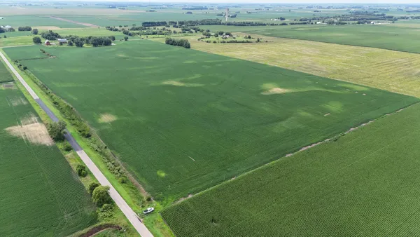 a view of a field with an ocean