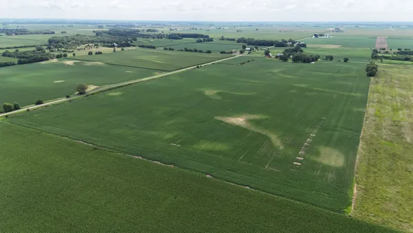 a view of a field with an ocean