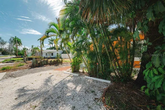 a row of lawn chairs under a large umbrella