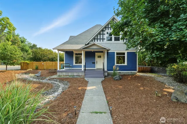 a front view of a house with a garden