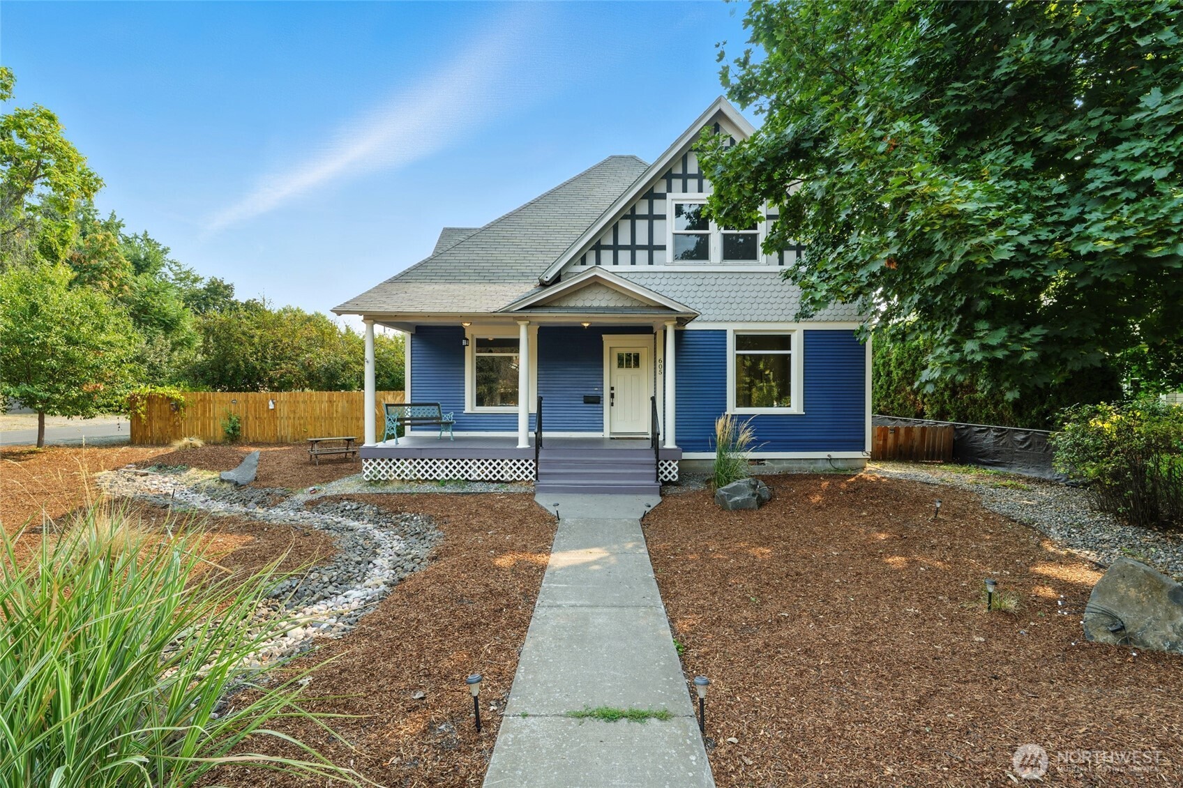 a front view of a house with a garden
