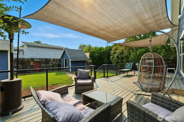 a balcony with wooden floor table and chairs