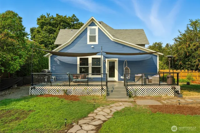 a front view of a house with yard and green space