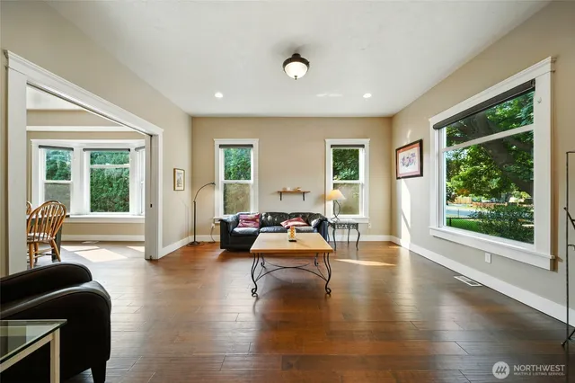 a living room with furniture and wooden floor