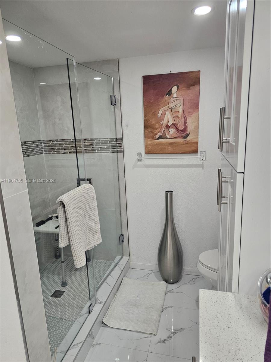 3910 Inverrary Boulevard, Unit 703B Lauderhill, FL 33319 - Photo 12 of 30 a bathroom with a toilet