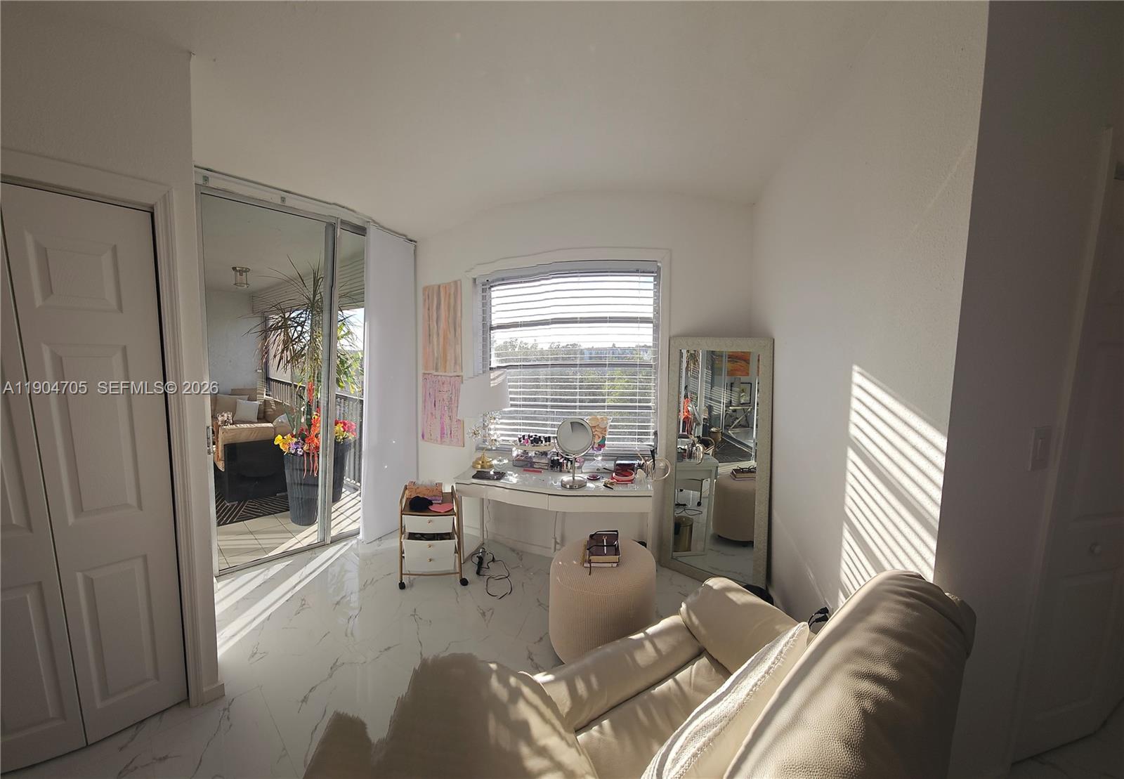 3910 Inverrary Boulevard, Unit 703B Lauderhill, FL 33319 - Photo 14 of 30 a living room with furniture and a large window