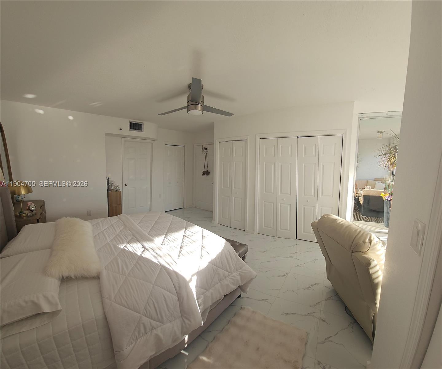 3910 Inverrary Boulevard, Unit 703B Lauderhill, FL 33319 - Photo 15 of 30 a bed room with a bed and furniture