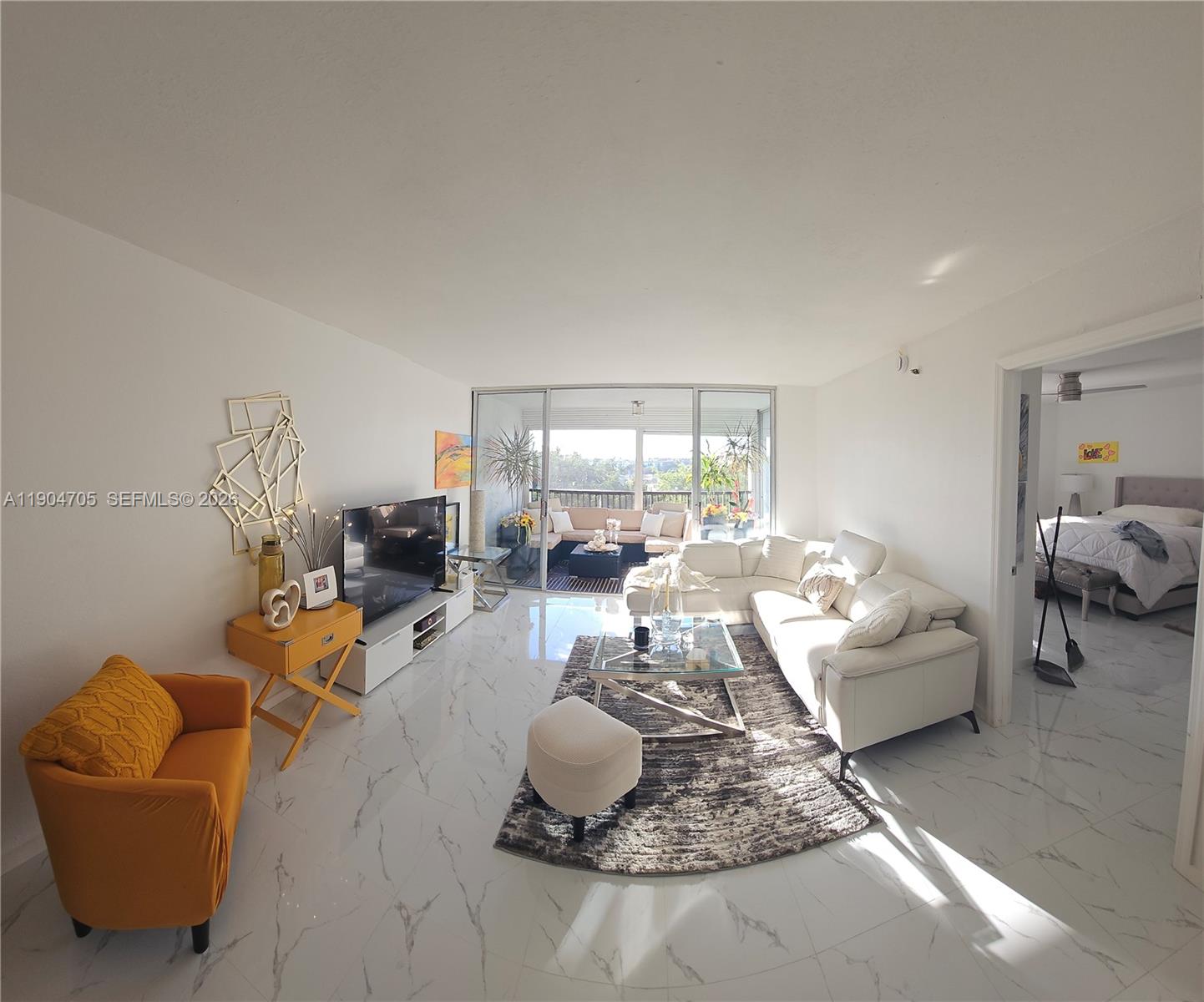 3910 Inverrary Boulevard, Unit 703B Lauderhill, FL 33319 - Photo 20 of 30 a living room with furniture and a large window