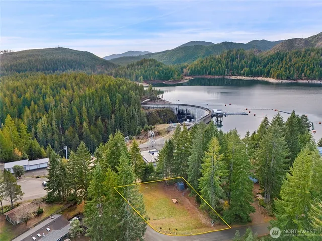 an aerial view of a house with garden space and a lake view