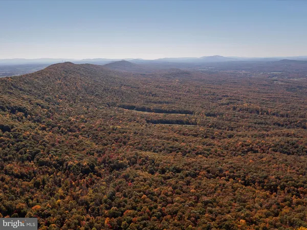 an aerial view of houses with yard and mountain view
