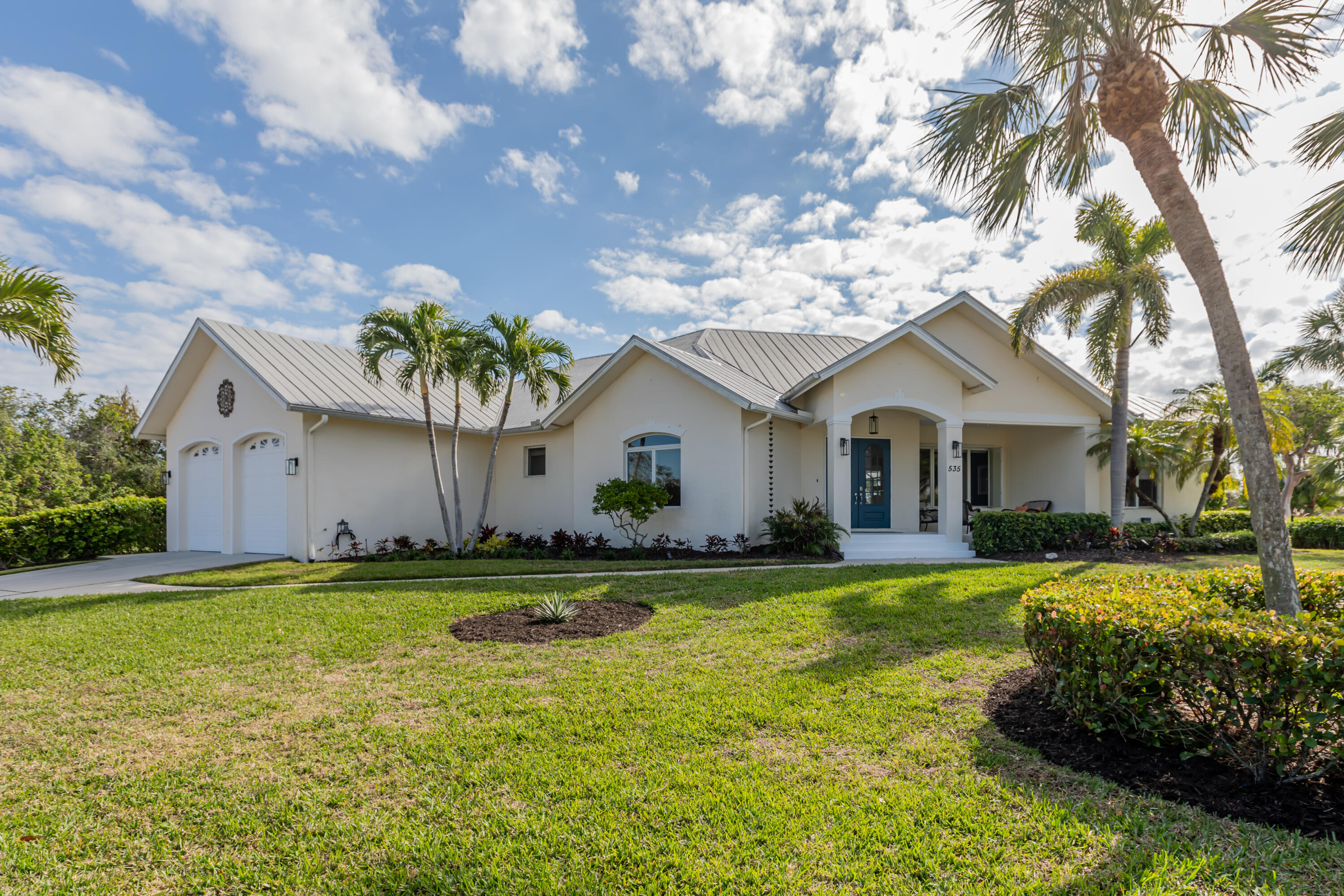 a view of a house with a yard and swimming pool