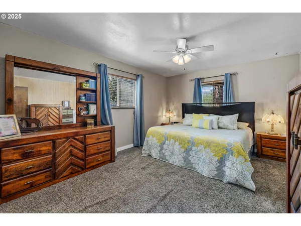 a bedroom with a large bed and a large mirror
