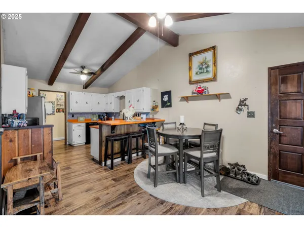 a dining room with furniture and a kitchen view