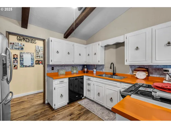 a kitchen with stainless steel appliances granite countertop a sink and cabinets