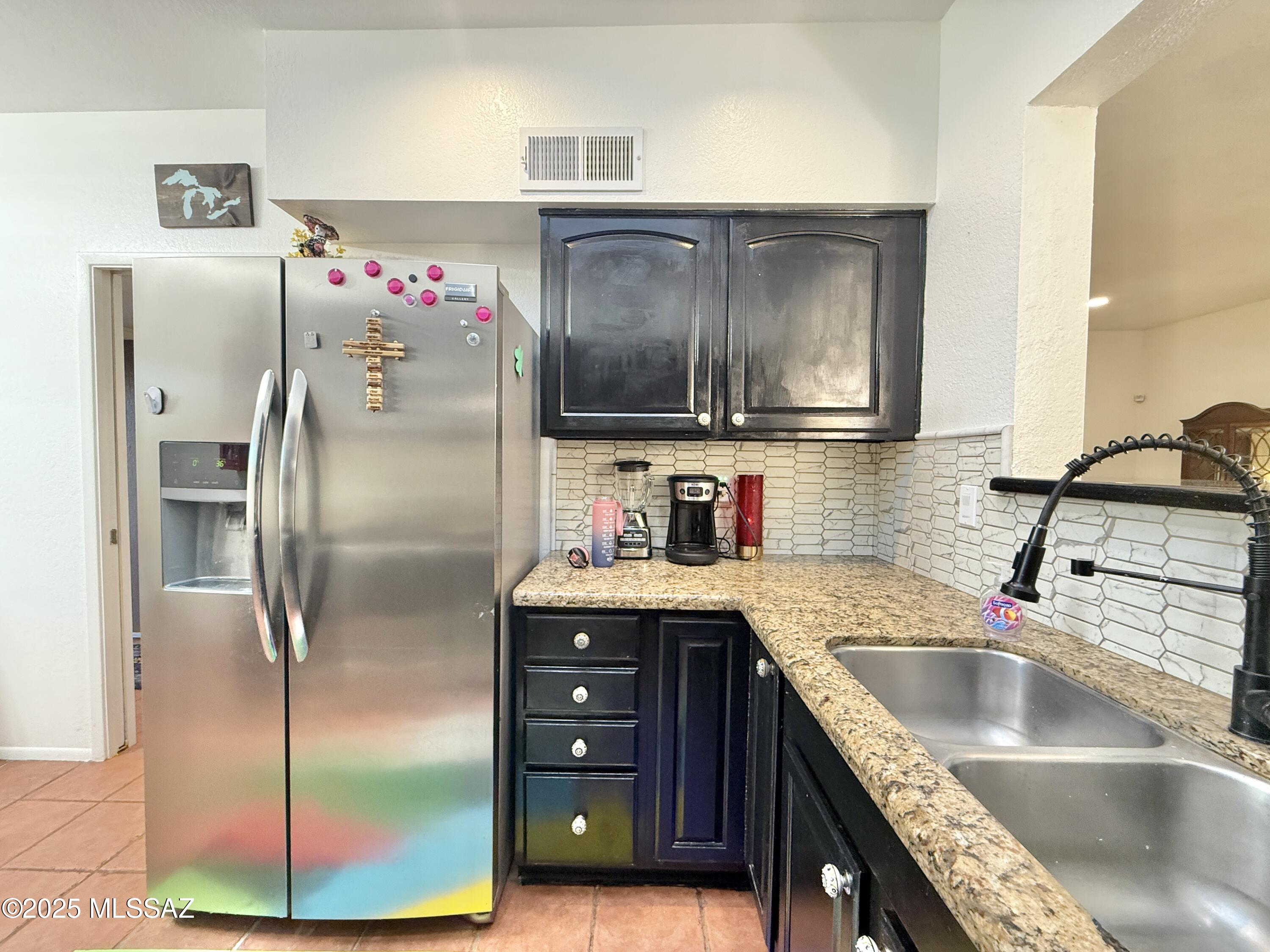 8110 East Rivenoak Circle Tucson, AZ 85715 - Photo 6 of 29 a kitchen with a refrigerator sink and cabinets