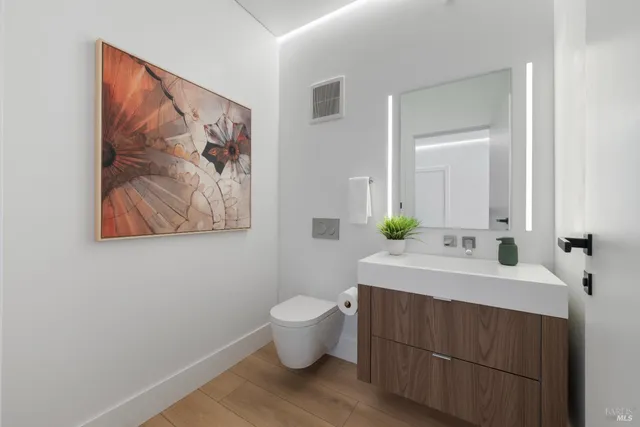 a bathroom with a sink mirror and toilet