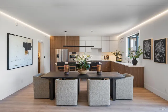 a dining room with kitchen island furniture a chandelier and kitchen view