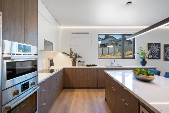 a kitchen with stainless steel appliances sink stove and cabinets
