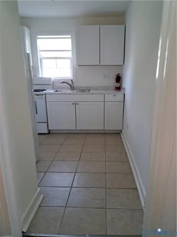 a kitchen with a sink a window and cabinets