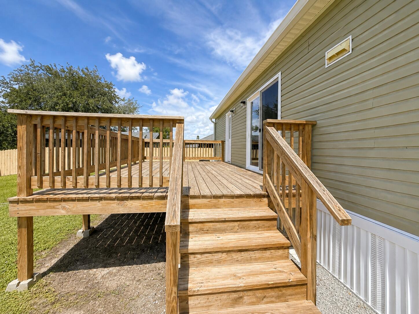 1121 Orange Loop Okeechobee, FL 34974 - Photo 27 of 33 Sunlit Wooden Deck and Stairs