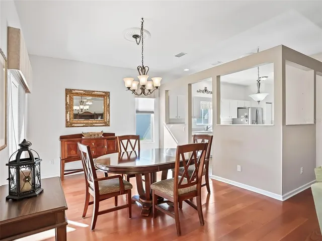 a view of a dining room with furniture wooden floor and a chandelier
