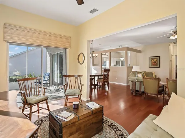 a living room with furniture a rug and a window