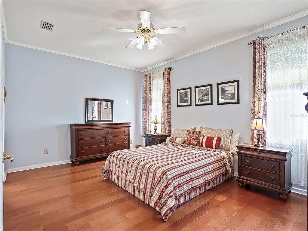 2323 Northwest 55th Avenue Road Ocala, FL 34482 - Photo 15 of 43 a bedroom with a bed and a chandelier