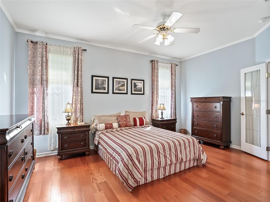 2323 Northwest 55th Avenue Road Ocala, FL 34482 - Photo 16 of 43 a bedroom with a bed and a chandelier