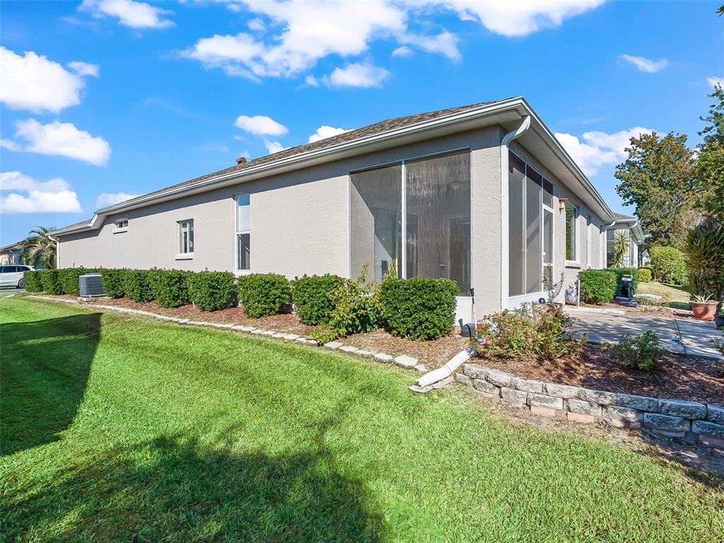 2323 Northwest 55th Avenue Road Ocala, FL 34482 - Photo 32 of 43 a backyard of a house with plants and outdoor seating