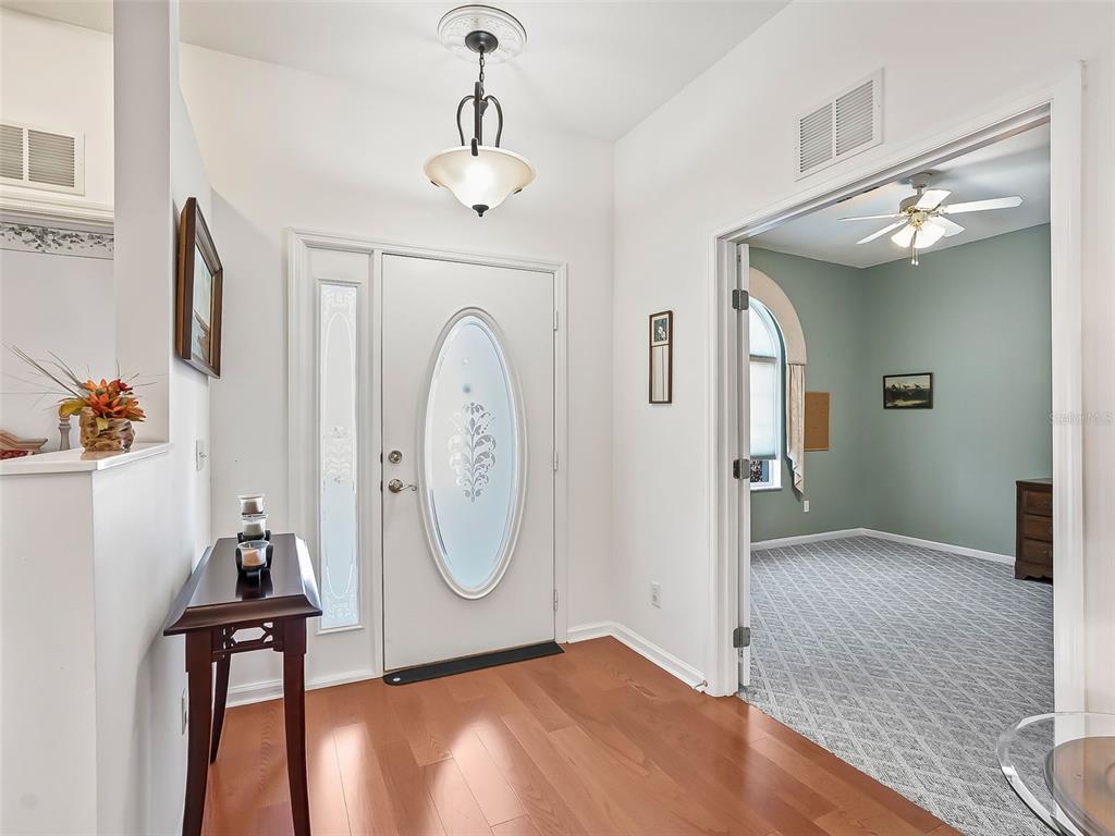 2323 Northwest 55th Avenue Road Ocala, FL 34482 - Photo 4 of 43 a view of a hallway with entryway wooden floor and front door