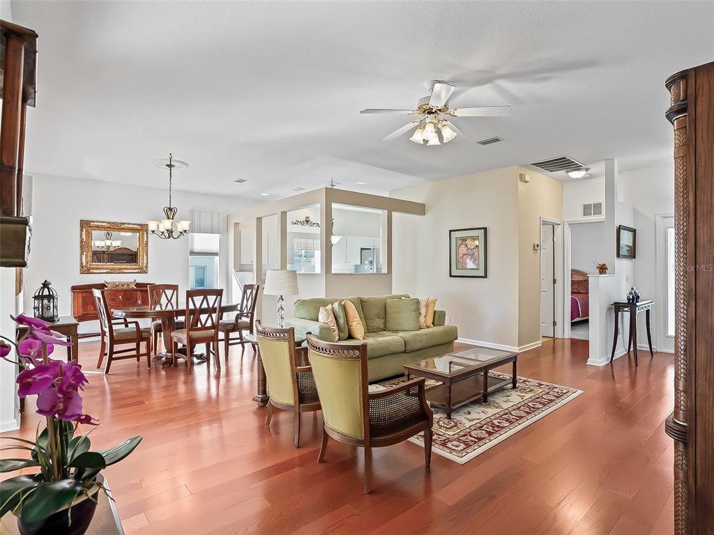 2323 Northwest 55th Avenue Road Ocala, FL 34482 - Photo 8 of 43 a living room with furniture a dining table and a chandelier