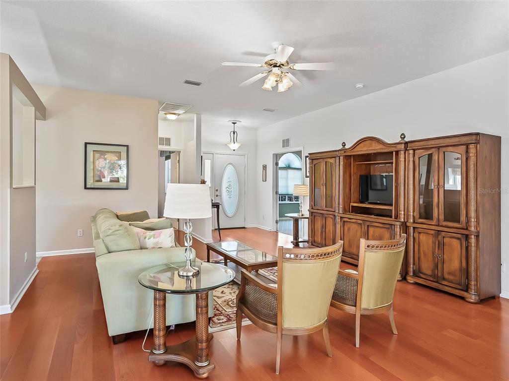 2323 Northwest 55th Avenue Road Ocala, FL 34482 - Photo 9 of 43 a view of a dining room with furniture and wooden floor