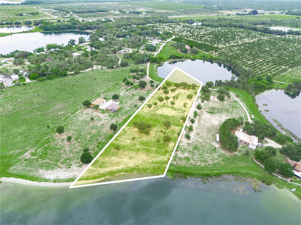 539 Eucalyptus Road Lake Wales, FL 33898 - Photo 7 of 19 a backyard of a house with a yard and outdoor seating