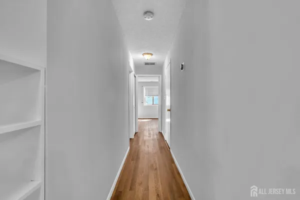 a view of an empty room and wooden floor