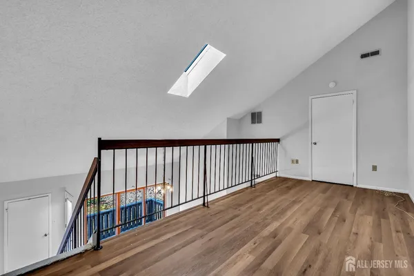 a view of staircase with railing and white walls