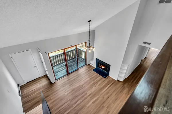 a view of a balcony with wooden floor and fence
