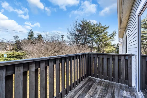 a view of a yard with wooden fence