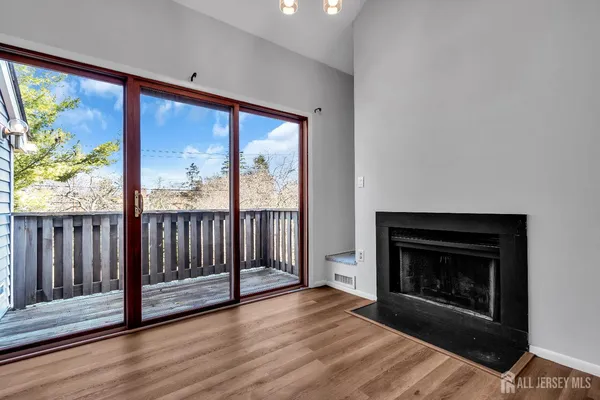 a view of a hallway with a fireplace and a chandelier