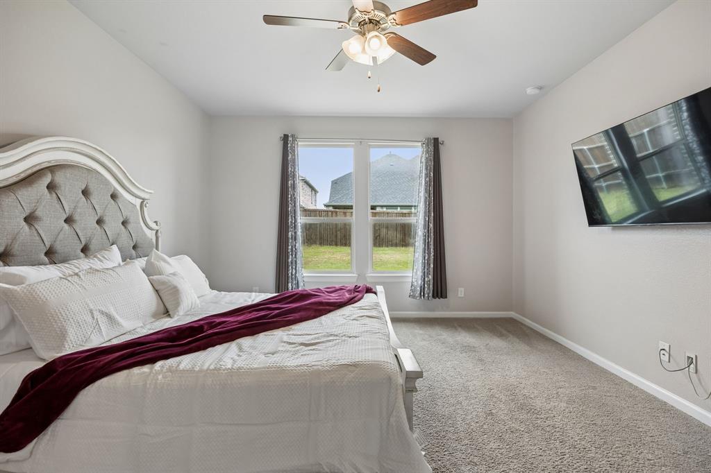 638 Hazeltine Road Red Oak, TX 75154 - Photo 19 of 29 a bedroom with a bed and window
